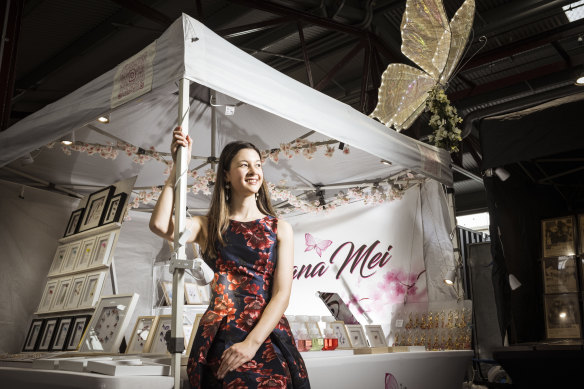 Kiana Mei Jackson gets ready for the crowds at the Queen Victoria night market, where she has been selling her designs throughout her VCE years. 