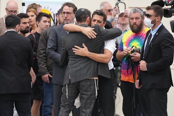 Israel’s Minister for Diaspora Affairs Amichai Chikli is embraced by a rabbi at a floral tribute near the Bondi Pavilion on Tuesday.