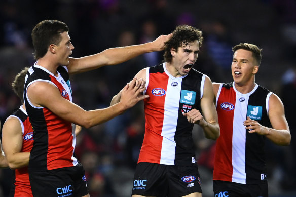 King is congratulated by team-mates after kicking a goal during Friday’s clash against the Cats.