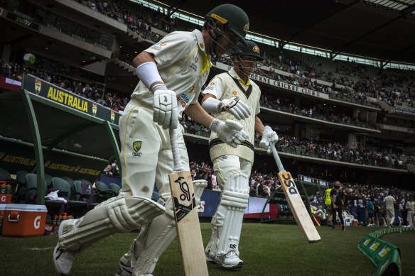 Harris and Warner make their way onto the MCG to begin Australia’s first innings. 