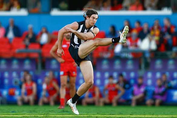 Harvey Harrison of the Magpies kicks a goal.
