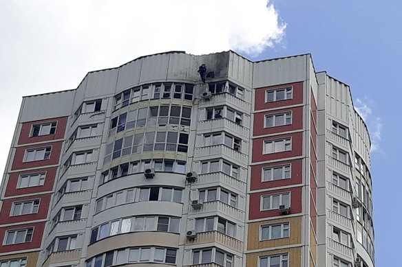 An investigator inspects damage after a Ukrainian drone attacked an apartment building in Moscow, Russia.