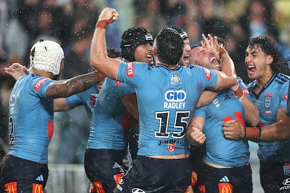 NSW celebrate after Tedesco’s late try clinched a famous come-from-behind victory.