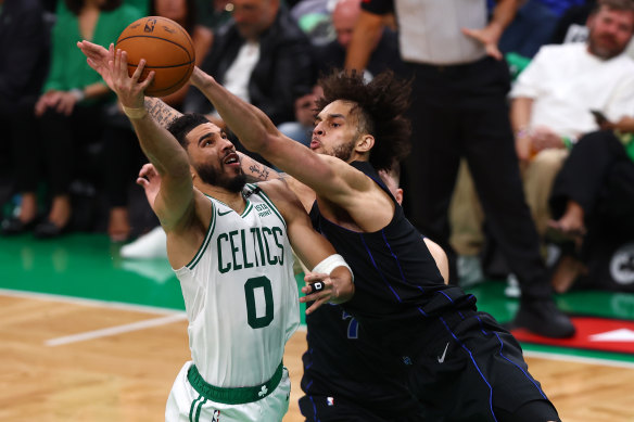 Jayson Tatum #0 of the Boston Celtics shoots the ball against Dereck Lively II #2 of the Dallas Mavericks.