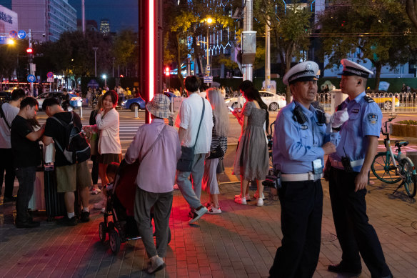 Police patrol the street Beijing’s Sanlitun district last week. 