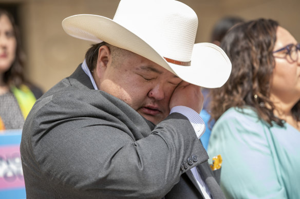 Emmett Schelling, Executive Director for the Transgender Education Network of Texas, cries at a rally in support of transgender children and their families at the Heman Marion Sweatt Travis County Courthouse in Austin, Texas, on Wednesday March 2, 2022.