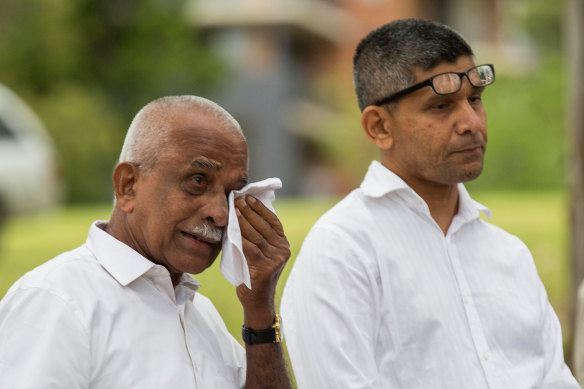 Prabha Kumar's father, Mahabala Shetty, and brother at the service in 2015.
