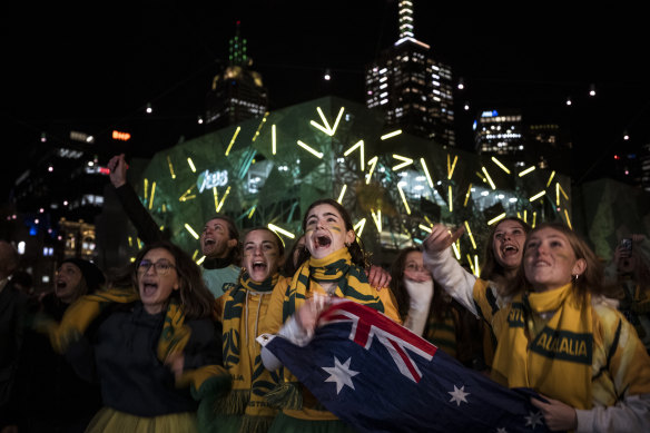 Matildas fans at Melbourne’s Federation Square celebrate the win over Denmark.