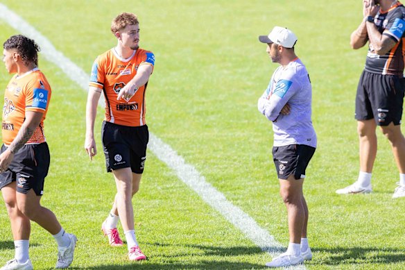 A rare moment of eye contact between Lachie Galvin and coach Benji Marshall.