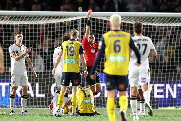 Referee Shaun Evans shows a red card to James Meredith.