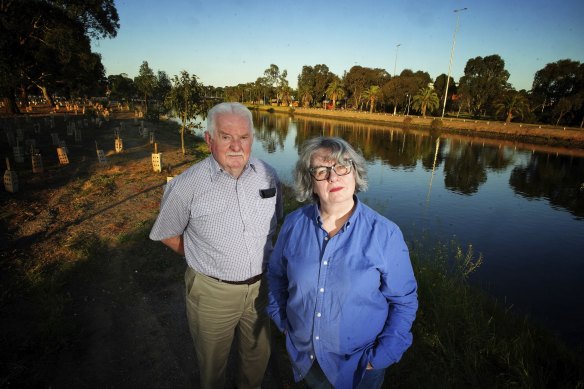 John Guegan and Madeleine Serle, whose homes were flooded last October, next to the Maribyrnong River on Friday.