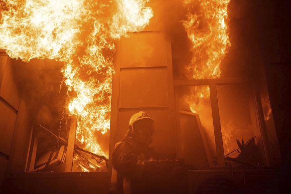 A firefighter works to extinguish a fire after a Russian attack in Odesa.