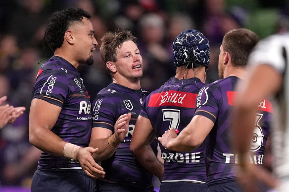 Harry Grant celebrates with teammates after scoring a try.