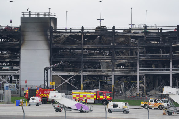 The burnt out shells of cars, buried amo<em></em>ngst debris of a multi-storey car park at Luton Airport.