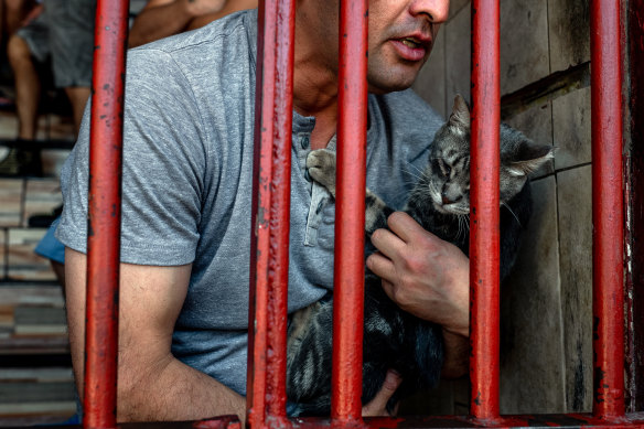 Carlos Nunez, an inmate, with a cat he named Feita, or Ugly.