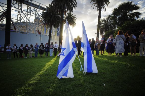 Jewish community members attend a vigil in St Kilda on Sunday,