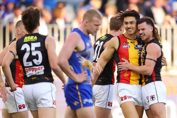 Mitch Owens and Jack Sinclair celebrate a goal for the Saints in their hard-fought win over the Eagles.