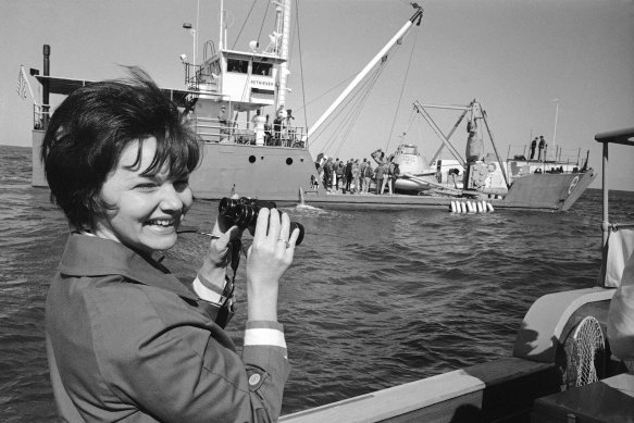 Marilyn Lovell watches the NASA motor vessel Retriever preparing to drop a mock-up of the command module into the water during a training period in 1968. 
