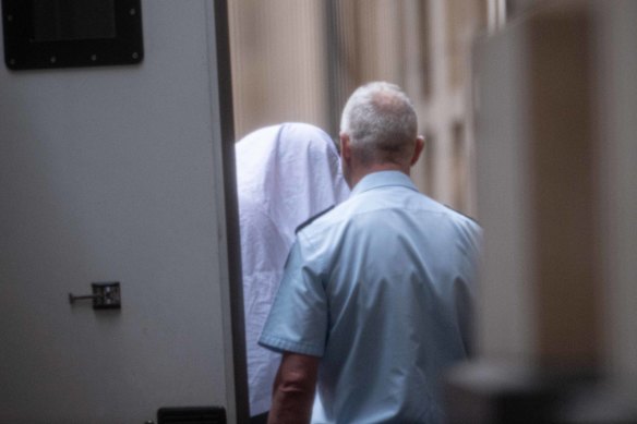 Xiaozheng Lin covered his face when arriving at court on Thursday.