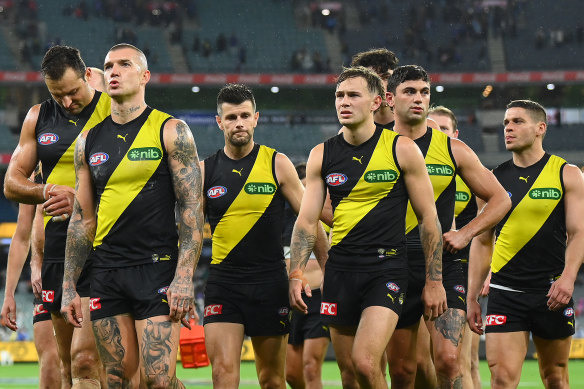 The dejected Tigers leave the field after the loss to the Bulldogs.