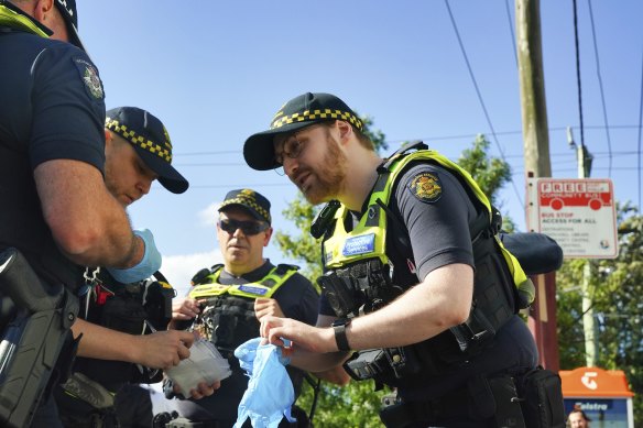 Police take away the bullet found outside the Adass Israel Synagogue.