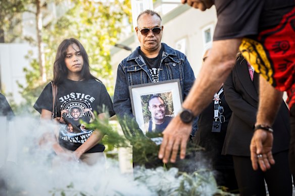 Winmar’s sister Margaret and father Jeffrey Anderson take part in a smoking ceremony outside the Victorian Coroners Court.