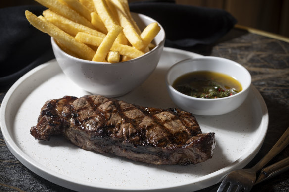 Porterhouse steak with chimichurri and chips.