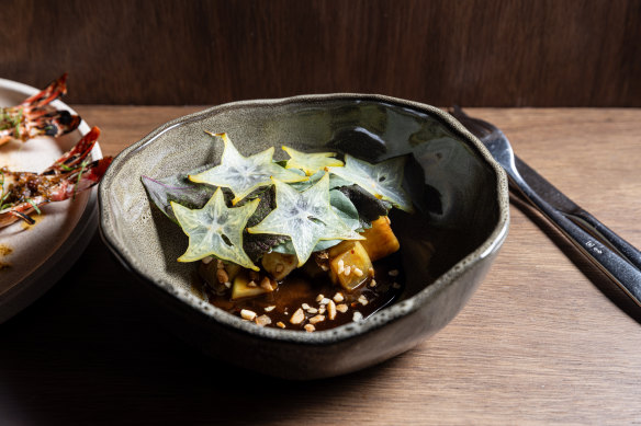 Rojak salad with papaya, pineapple, star fruit, sorrel and broad bean leaves and macadamia.