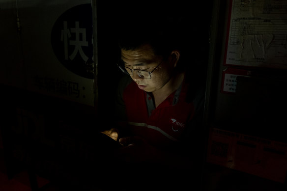 JD logistics courier Shi Hailong at work late at night in Beijing in June.