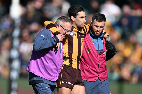Chad Wingard is helped from the field in Launceston.