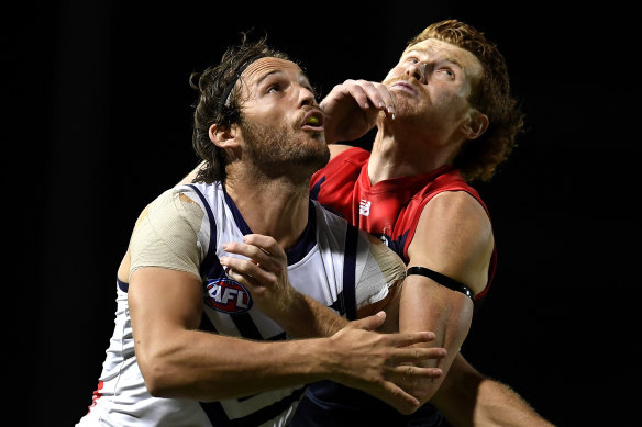 Fremantle's James Aish battles Oskar Baker of the Demons.