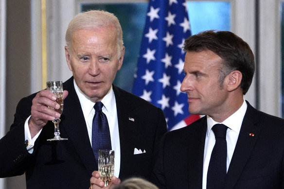 US President Joe Biden and French President Emmanuel Macron toast during a state dinner.