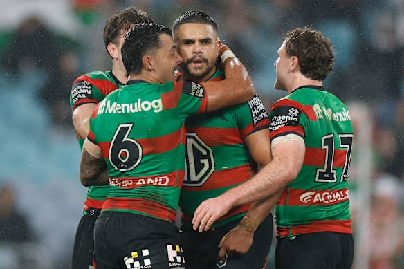 Ice cold: Latrell Mitchell is mobbed by his teammates.