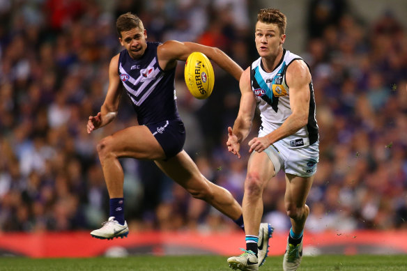 Robbie Gray of the Power handballs against Stephen Hill of the Dockers.