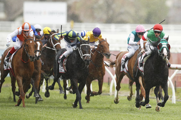 Damian Lane rides Mer De Glace, right, to victory at the 2019 Caulfield Cup. 