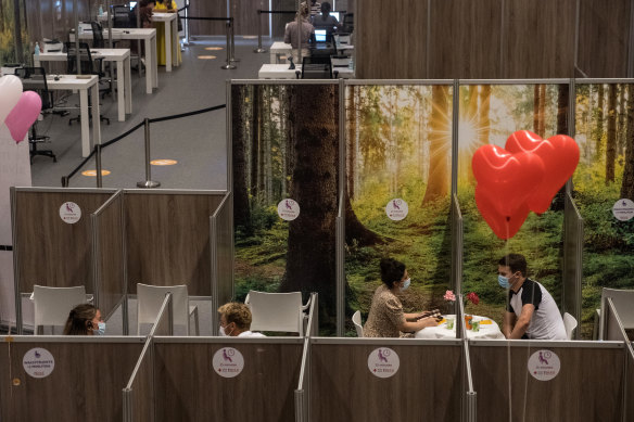 People enjoy a blind date in the waiting area after being vaccinated in Haarlem, Netherlands. Haarlem’s municipal health service invited area residents to sign up for a blind date during the 15-minute waiting period after receiving their shots. 