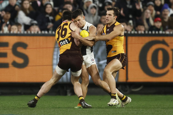 Rugged night: Nick Daicos collided with James Blanck and was hurt after this third term incident.
