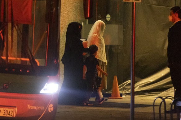 Two women and a child from Afghanistan arrive at the Hyatt Hotel in Perth.