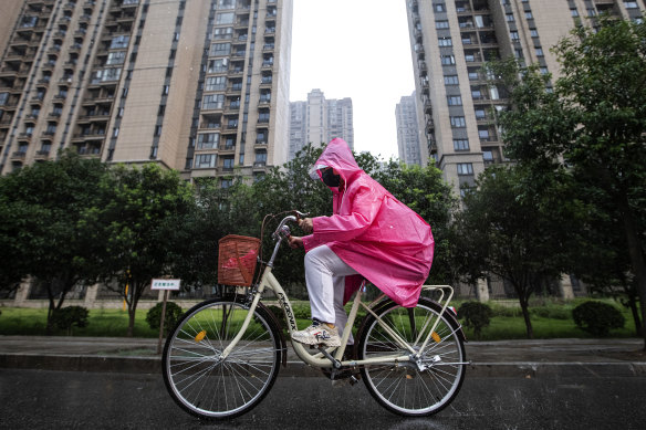 A resident cycles through an Evergrande community in Wuhan.