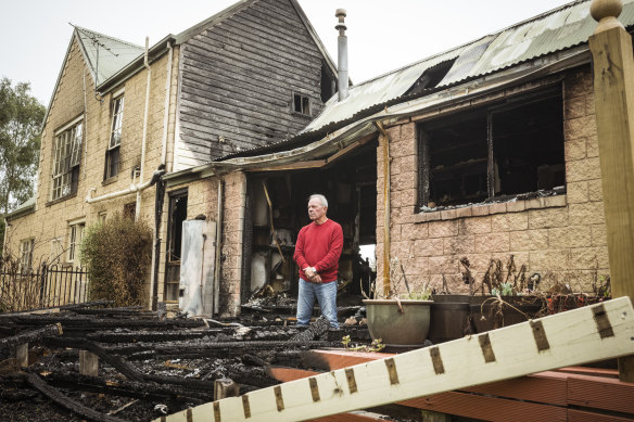 Jim Johnstone in the burnt remnants of his Sunbury home.