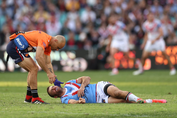 James Tedesco receives assistance after being floored by Jordan Pereira.