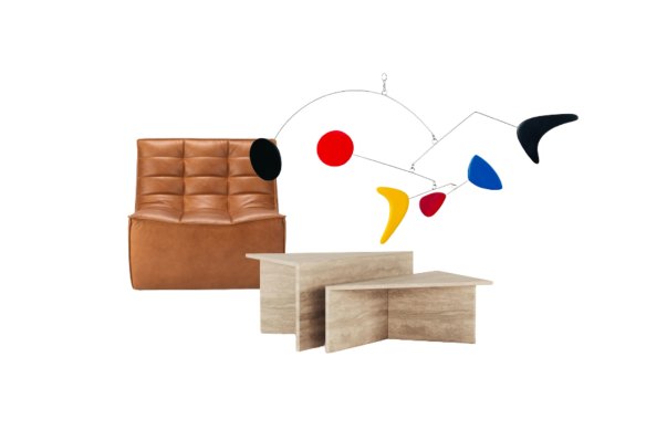 “Slouch” sofa chair; Abstract art hanging; “The Duo” travertine coffee table.