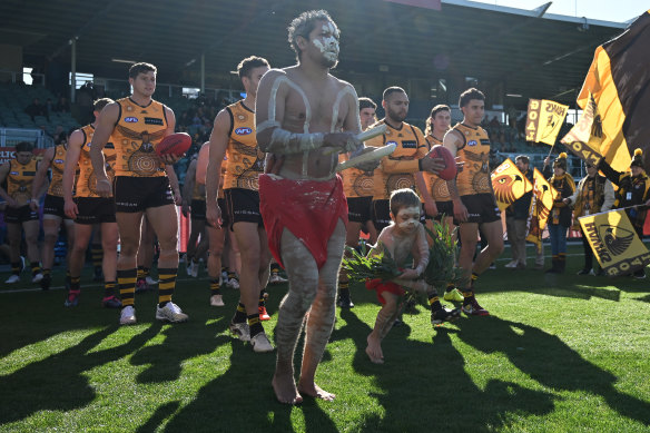 Jarman Impey of the Hawks leads out the team.