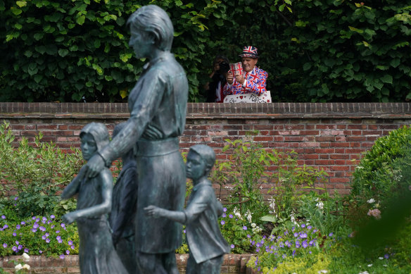 Members of the public view the statue of Diana, Princess of Wales, in the Sunken Garden at Kensington Palace.