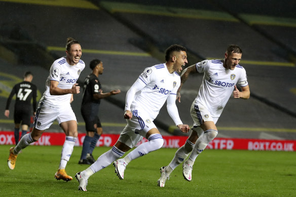Rodrigo (centre) celebrates his goal for Leeds.