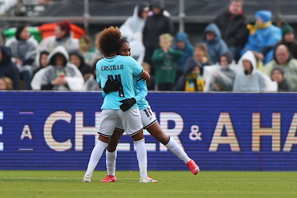 Castillo and King hug after her goal.
