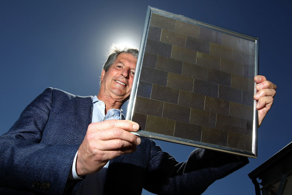 UNSW's Professor Martin Green, a solar energy pioneer, holds the world's first 23 per cent efficient solar module developed back in 1999. (Photograph from December 2017.)