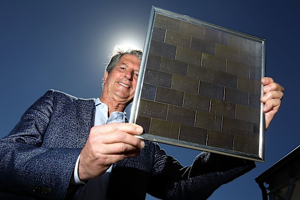 UNSW's Professor Martin Green, a solar energy pioneer, holds the world's first 23 per cent efficient solar module developed back in 1999. (Photograph from December 2017.)