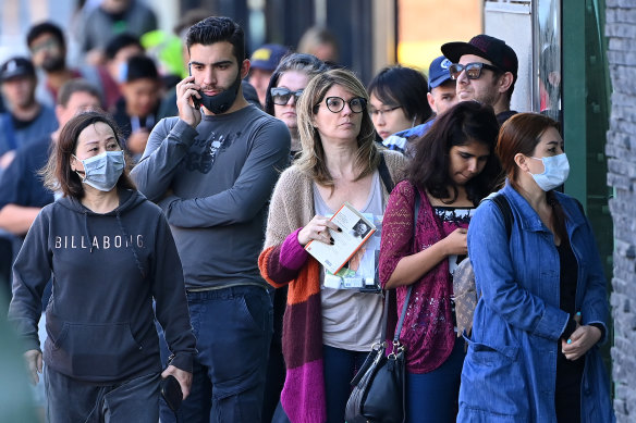 The nation must decide its best path forward: People lining up at a Centrelink office amid the COVID-19 shock.