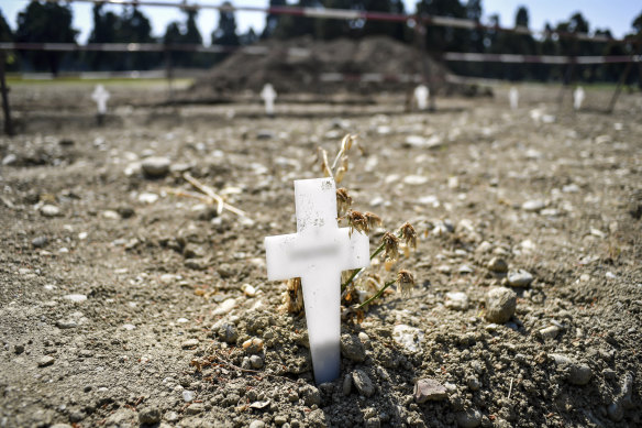 White crosses delimiting the areas for new burials are scattered at the Maggiore cemetery in Milan. The country's death toll topped 25,000 this week.